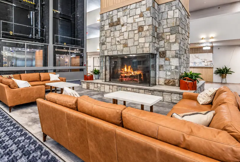 Leather sofas around the stone fireplace in the Mountain Lodge lobby