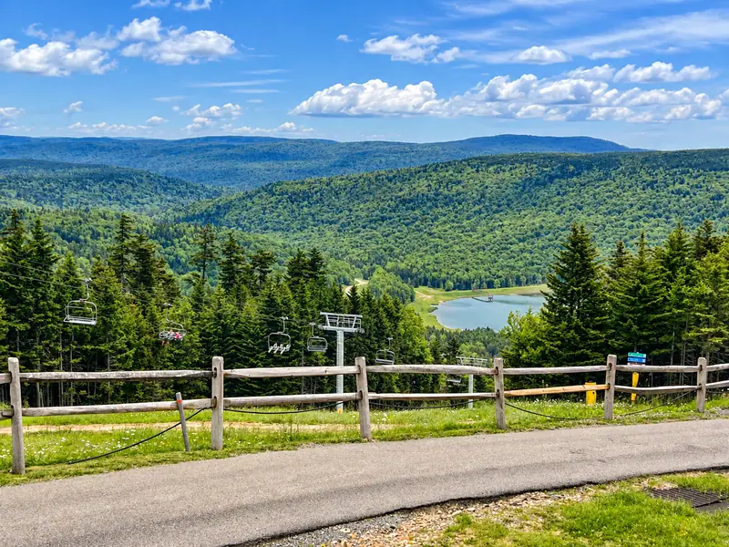 Summer view from Mountain Lodge over green ridges and a lake
