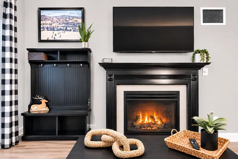 Fireplace and TV at Seneca 113 with a buffalo check accent