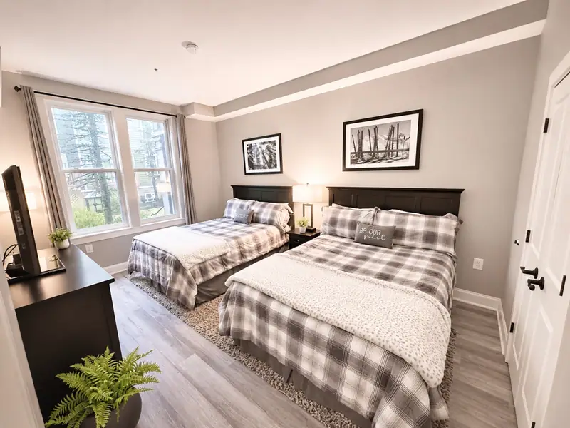 Two plaid beds by the window at Seneca 113