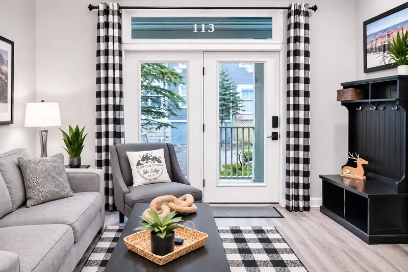 The porch door at Seneca 113 under its 113 transom, with the sofa beside it