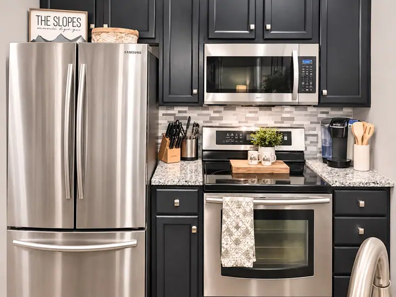 Stainless range, microwave and fridge in the Seneca 113 kitchen