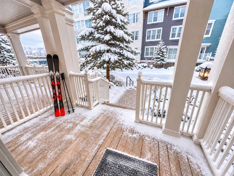 Skis leaning on the snowy porch at Seneca 113